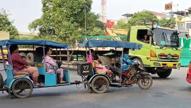 Waduh, Odong-odong di Cilincing Bawa Penumpang di tengah Impitan Truk-Truk Besar