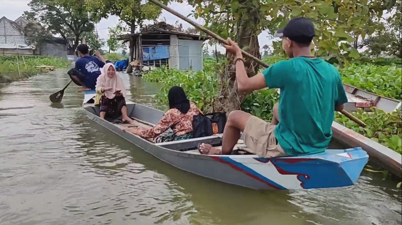 Jalan Terendam Banjir, Warga Lamongan Aktivitas Pakai Perahu