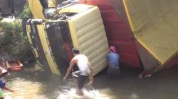 Truk Terbalik di Sungai, Warga Jombang Berebut Susu Kemasan Hanyut