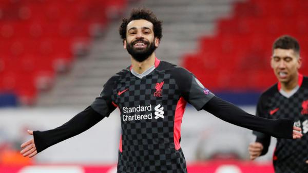 Liverpool Mohamed Salah Winger Liverpool Mohamed Salah melakukan selebrasi usai menjebol gawang RB Leipzig pada leg I babak 16 besar Liga Champions 2020/2021 di Puskas Arena, Budapest, Rabu (17/2/2021) dini hari WIB. (Foto: REUTERS)