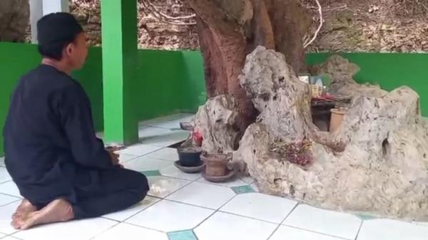 PETILASAN NYI RAMBUT KASIH Juru kunci petilasan Sindangkasih, Saki, sedang berdoa. (Foto: iNews/M ZENI JOHADI)
