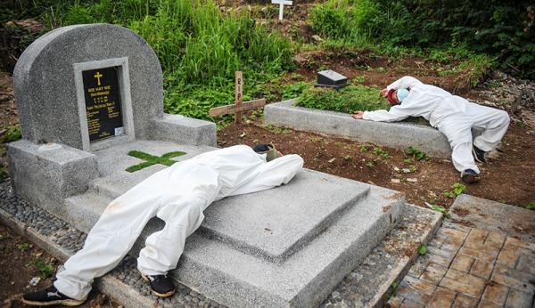 Petugas Covid-19 tertidur di atas makam karena kelelahan (ANTARA FOTO/Raisan Al Farisi)