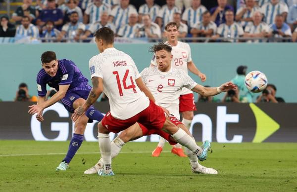 Penyerang Argentina Julian Alvarez Piala Dunia Penyerang Argentina, Julian Alvarez (kiri) melesatkan bola ke gawang Polandia pada laga terakhir Grup C Piala Dunia 2022 di Stadion 974, Doha, Kamis (1/12/2022). (Foto: REUTERS)
