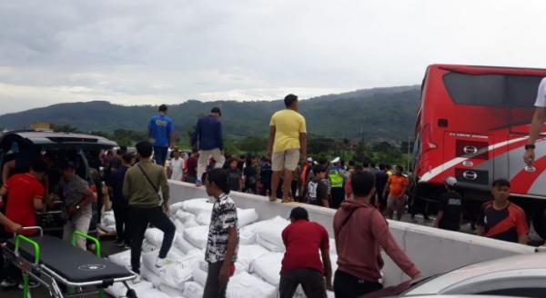 Petugas mengevakuasi korban kecelakaan maut bus pariwisata menabrak truk wingboks di Tol Pandaan-Malang, Senin (23/12/2024). (Foto: MPI/Avirista)