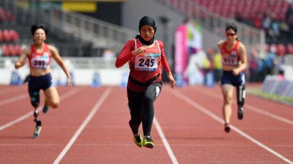 Atlet lompat jauh Indonesia Maria Natalia Londa membentangkan Bendera Merah Putih setelah memenangkan pertandingan Final Lompat Jauh Putri SEA Games ke-30 di Stadion Atletik New Clark, Filipina, Minggu (8/12/2019). (Foto: ANTARA/Nyoman Budhiana)